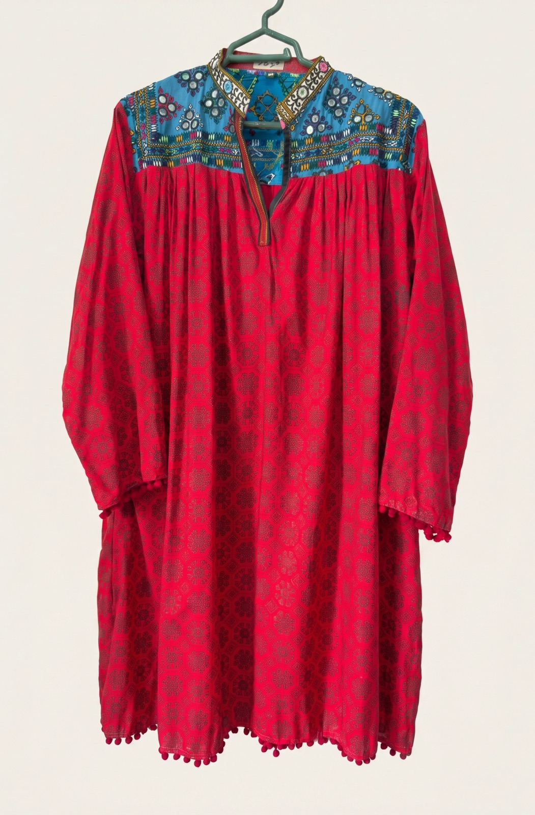 Hand-embroidered red kurta with a turquoise mirror-work yoke, handmade in Tharparkar, Sindh