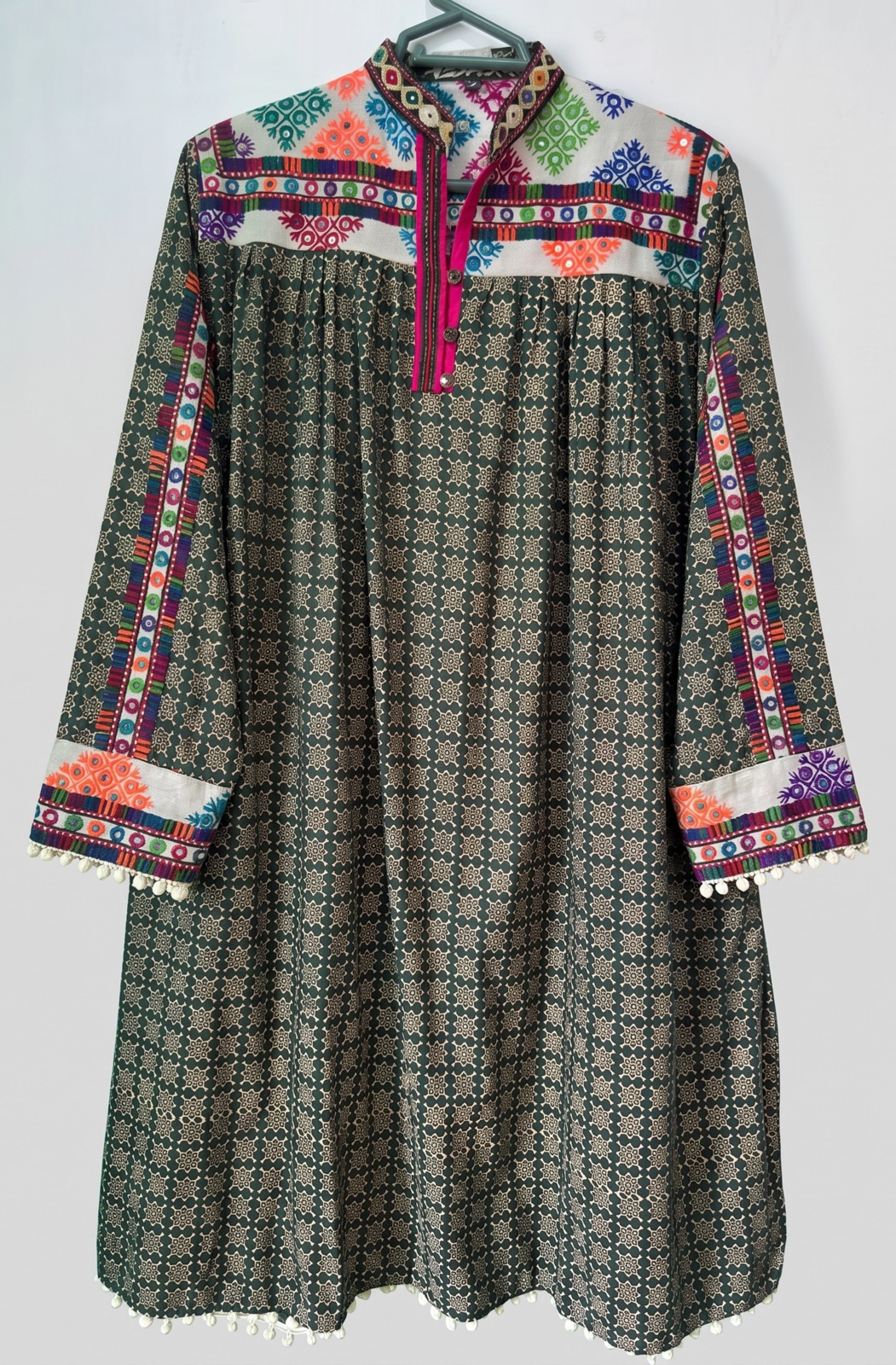 Hand-embroidered dark green kurta with dense all-over multicolour cross-stitch embroidery, handmade in Tharparkar, Sindh
