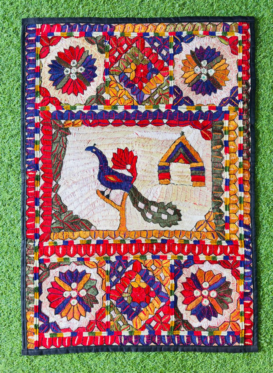 Hand-embroidered Sindhi wall hanging with a bird and cottage folk motif