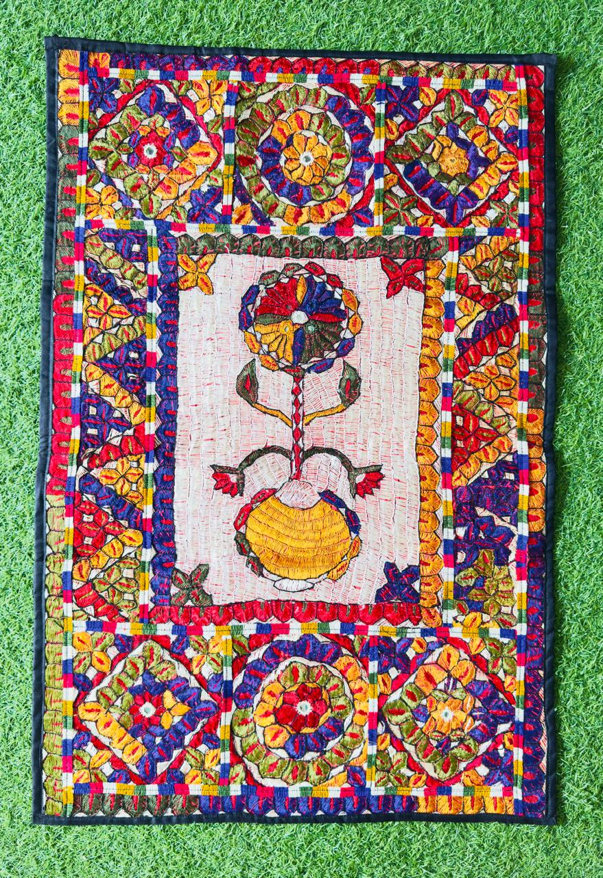 Wall hanging with a floral vase motif