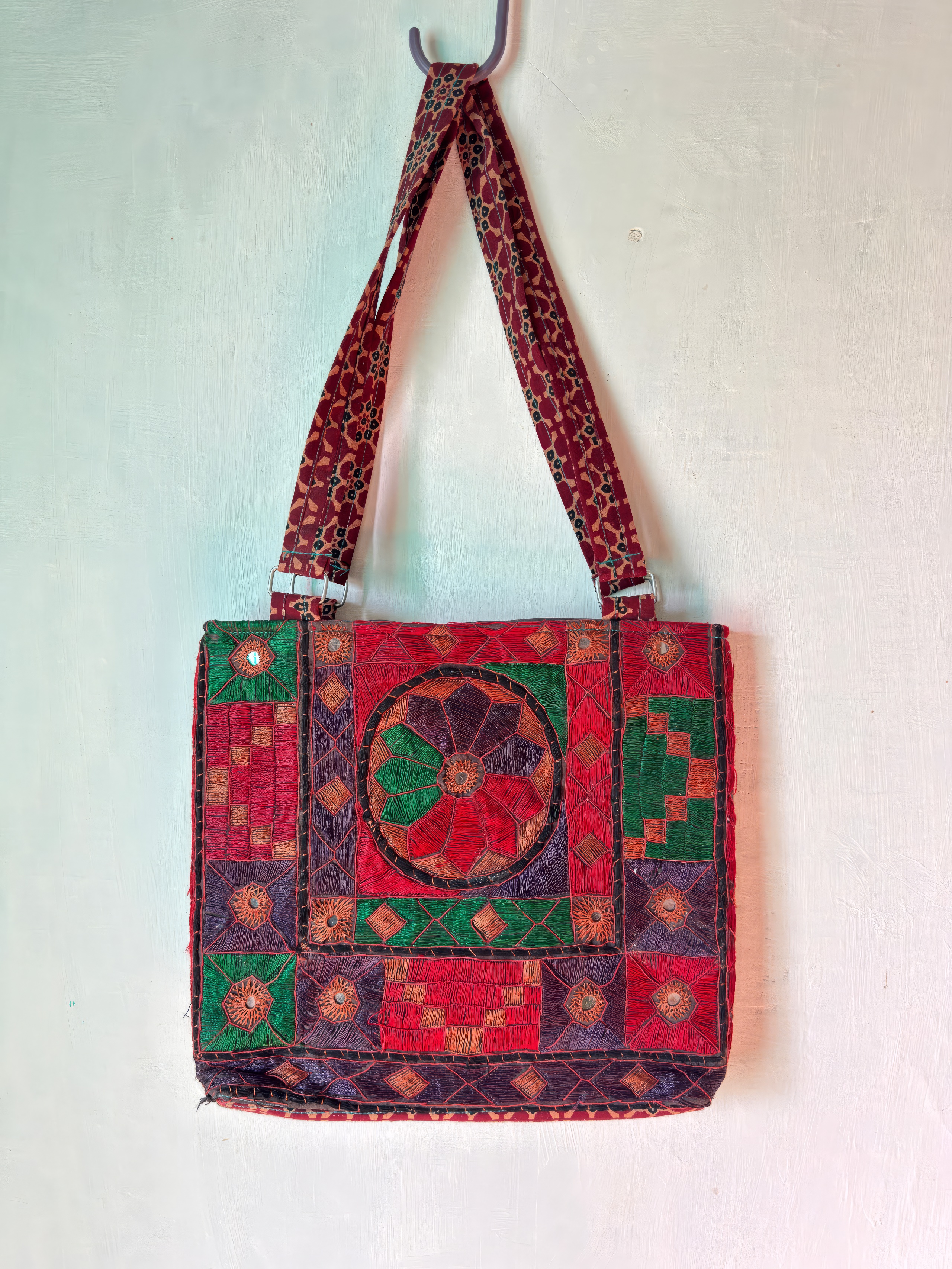 Tharparkar embroidered shoulder bag with bold mirror-work medallion