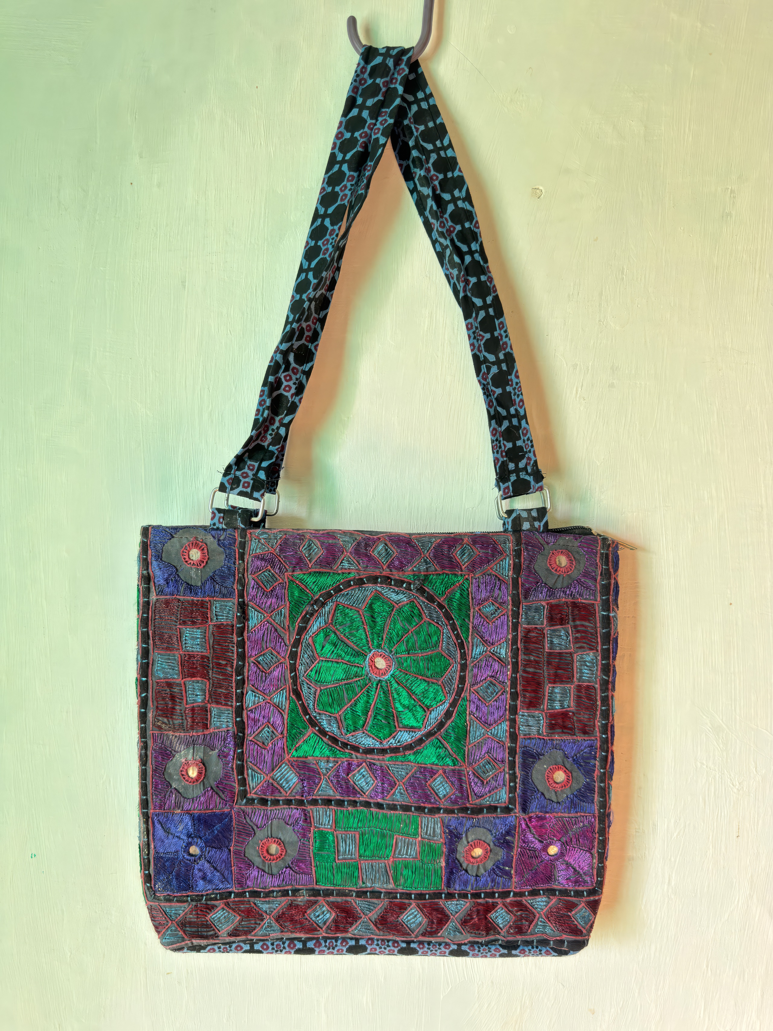 Tharparkar embroidered shoulder bag in purple and teal with a geometric mirror-work medallion